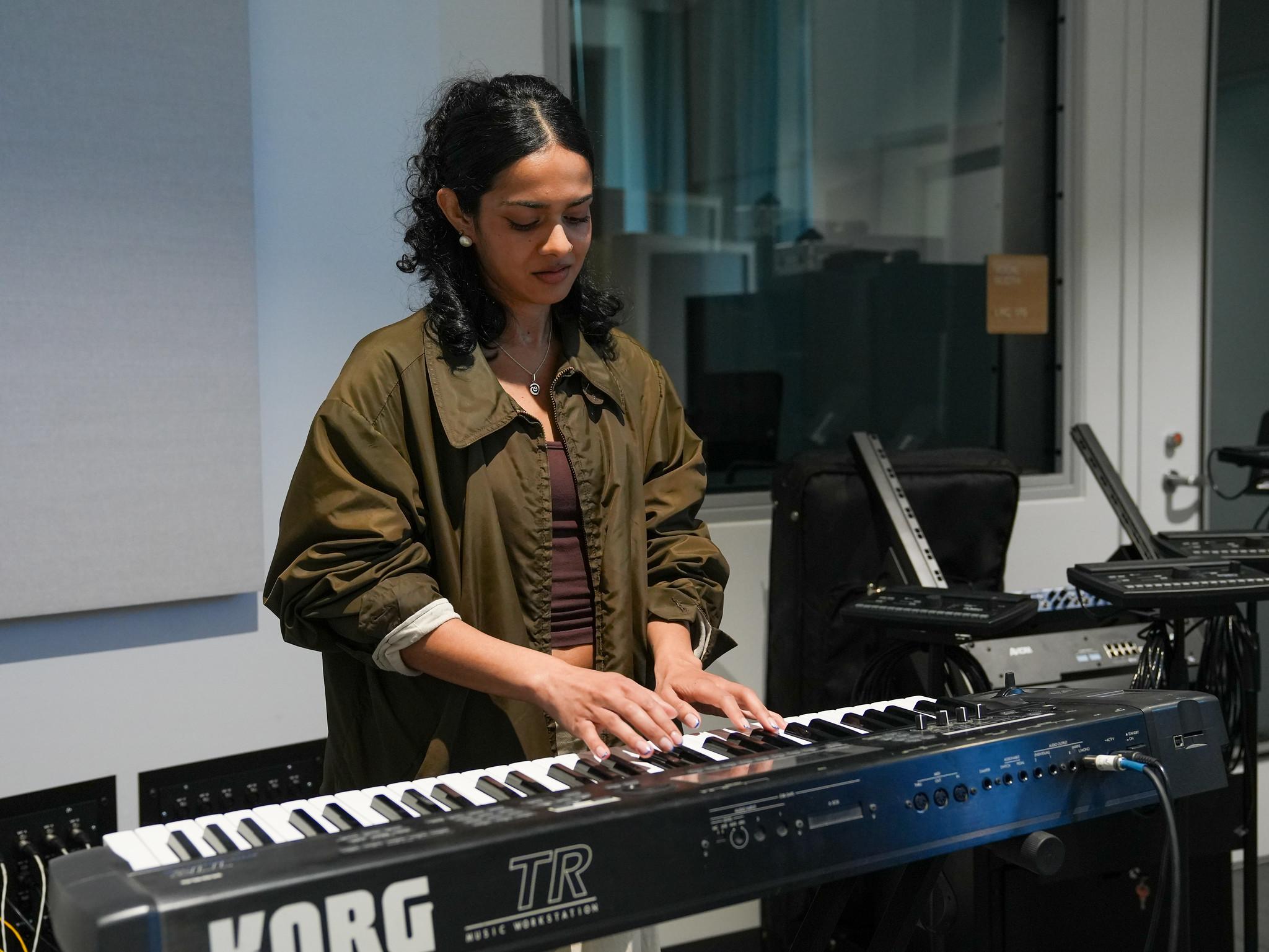 female student playing a keyboard