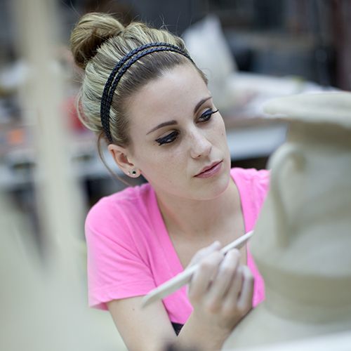 Female student working on ceramic project