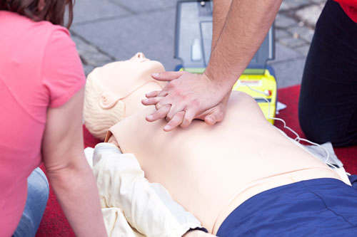 Students practicing CPR with dummy Students practicing CPR with dummy