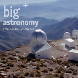 Mountain observatory with multiple white telescope domes under a clear sky