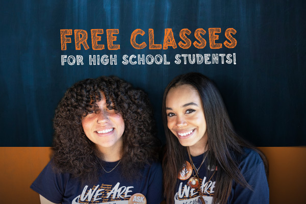 Two students smiling under text free classes for high school students