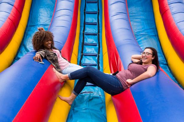 Two students chilling on giant inflatable slide