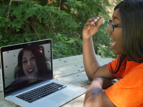 Students speaking to instructor on computer