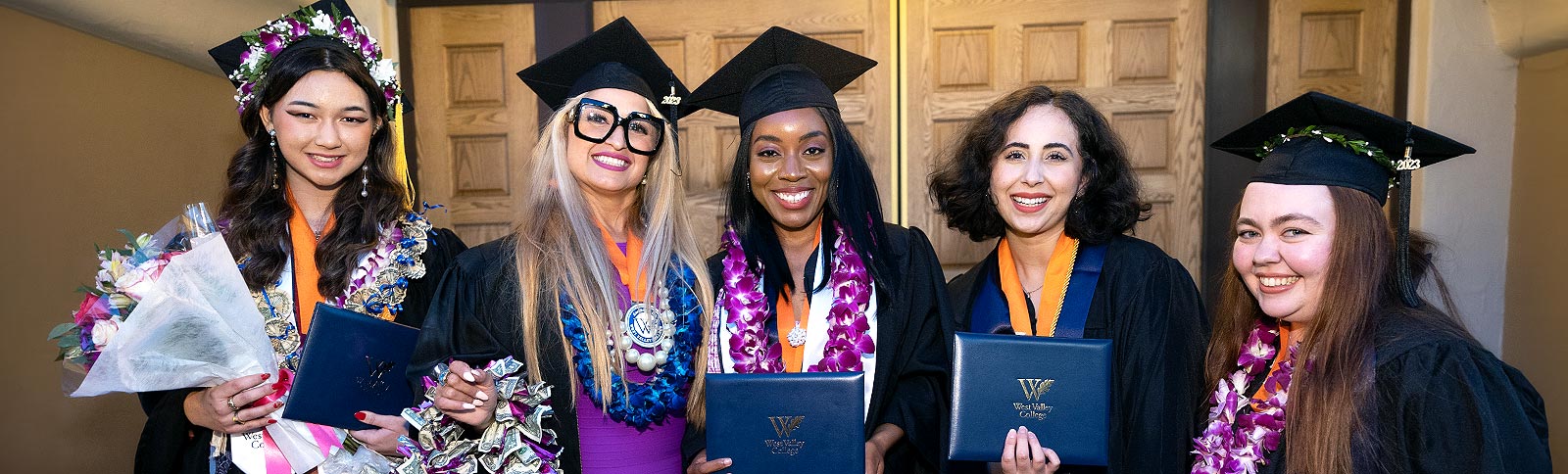 Smiling graduate gals