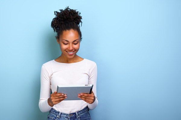 Young woman smiling with ipad