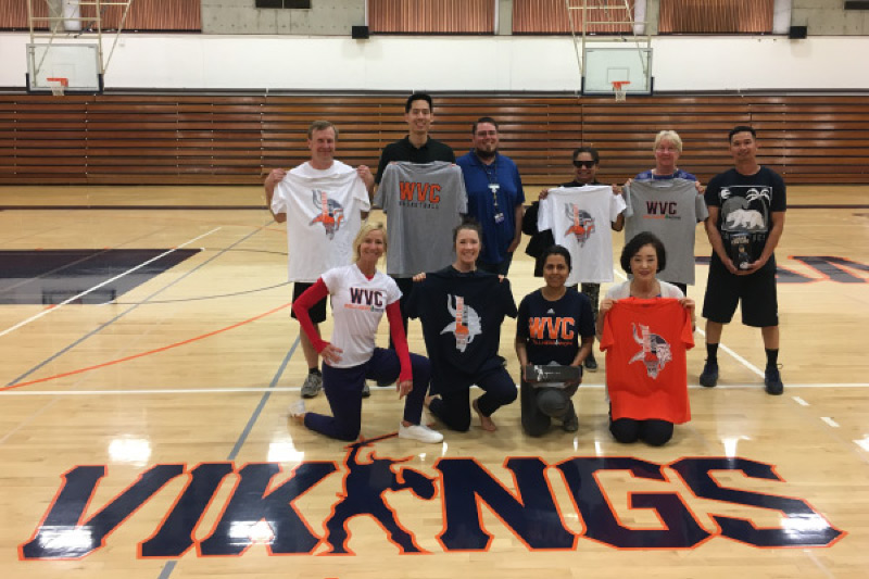 West Valley College employees posing with shirts in gym