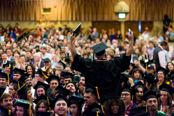 Single graduate standing up and facing crowd