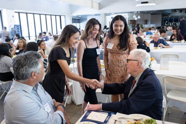 Students shaking hands with donors