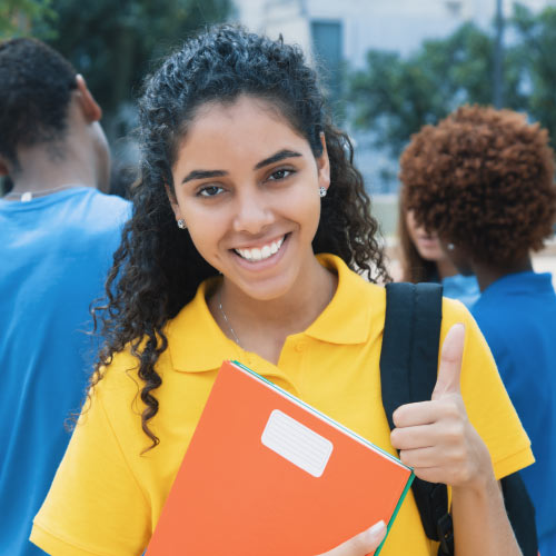 Female student in yellow shirt with notebook