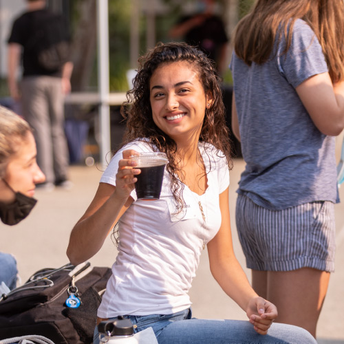 Student smiling with cup of coffee