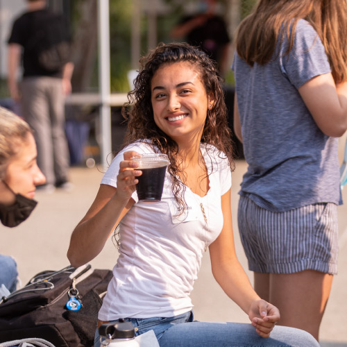 Female tudent smiling with coffee cup