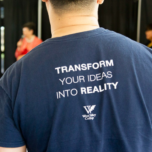 Back of student shirt that says "Transform Your Ideas into Reality"