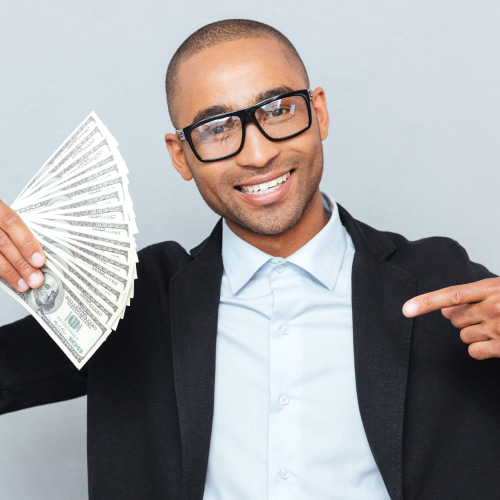 Student smiling and pointing at money