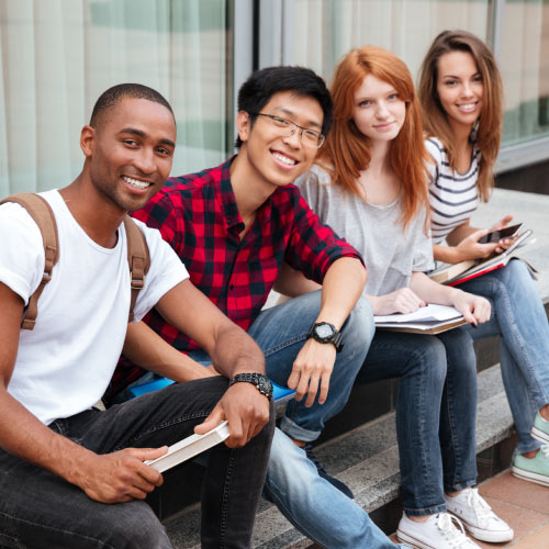 Four ethnically diverse smiling students