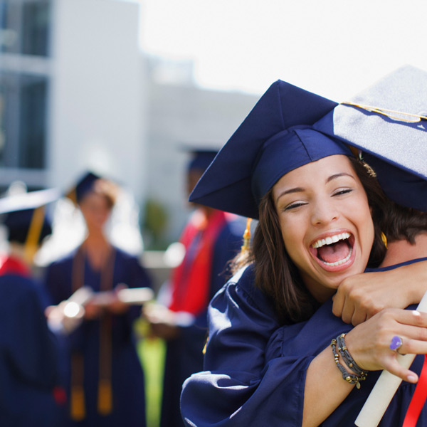 Happy female graduate hugging another human