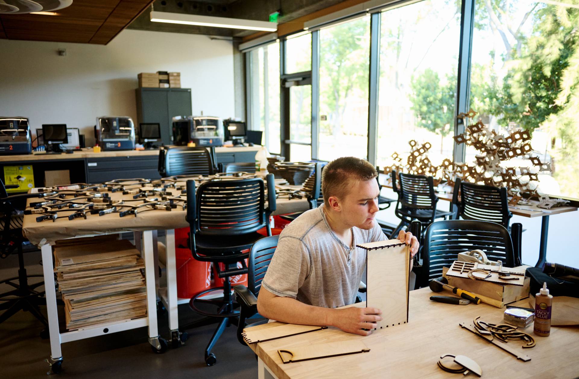 industrial design student building models with laser cut cardboard