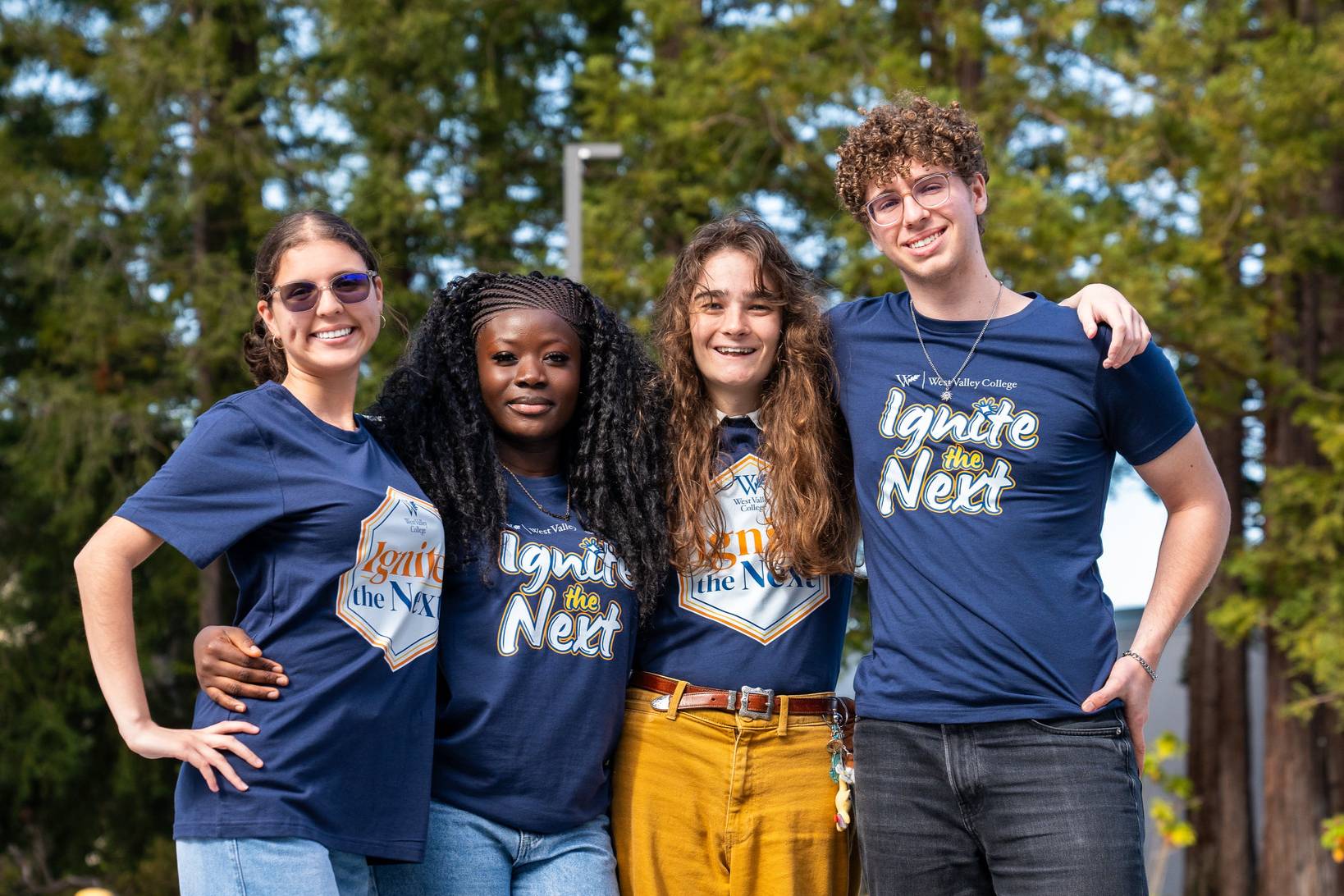four student ambassadors wearing ignite the next t shirts