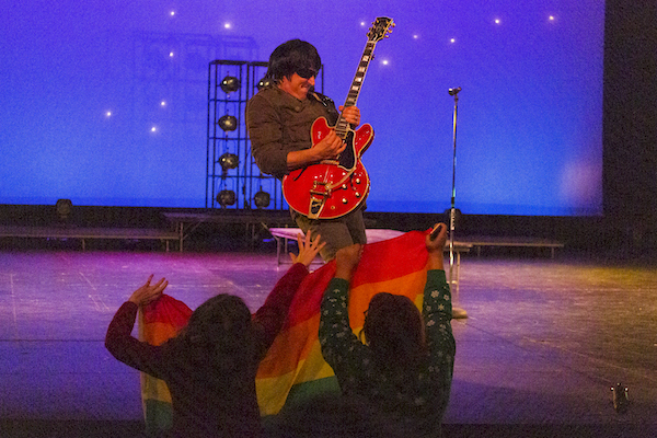 President Brad Davis playing his guitar