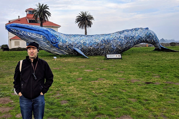 Dr. Chin in front of a 82-foot-long plastic whale