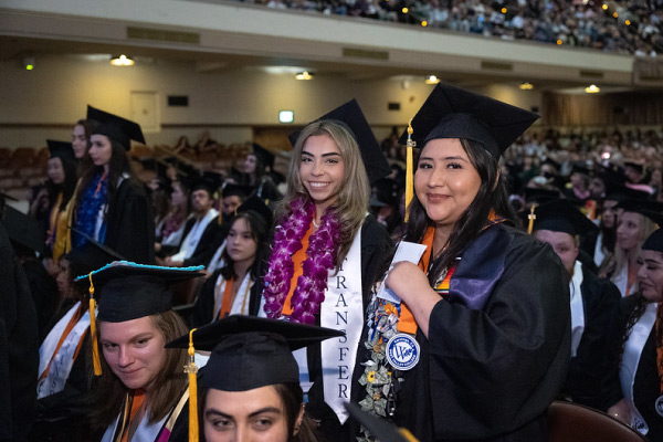 Two Latinx graduates