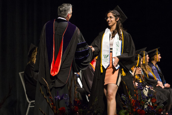 Karin Shamardani walking across the stage at the 2017 WVC Commencement Ceremony.