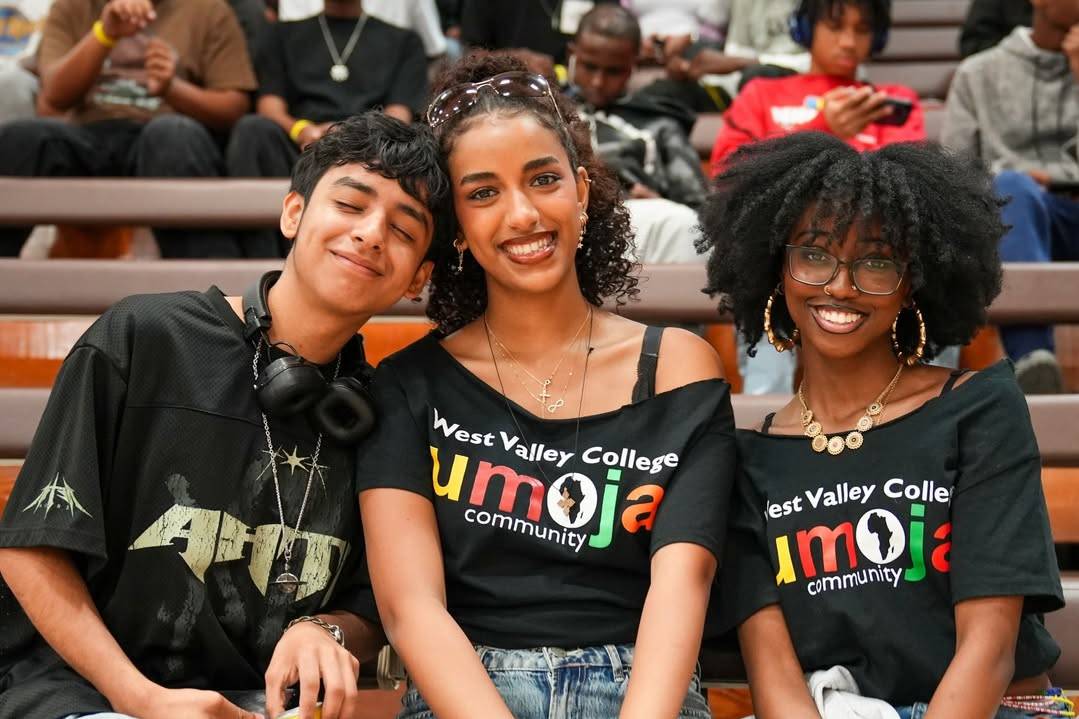 three umoja students wearing emoja branded black tshirts