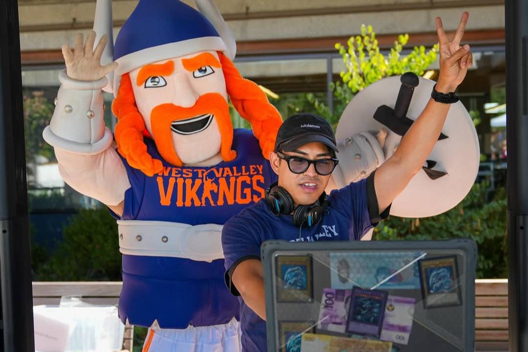 vik the viking mascor behind a dj with headphones and sunglasses