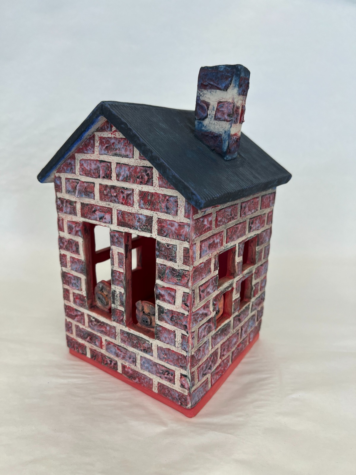 ceramic sculpture of a red brick house