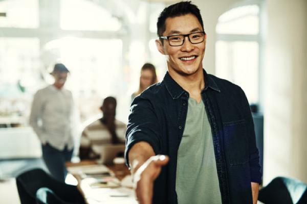 Young Asian man extending handshake