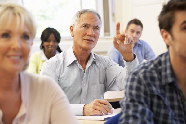 Older student raising finger in class