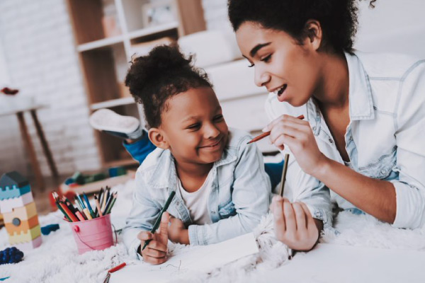 Parent doing art with child Parent doing art with child