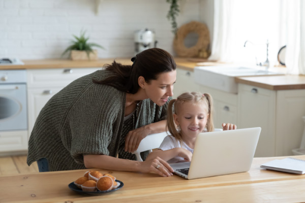 Adult with child on laptop