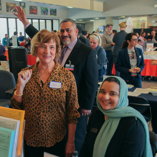 Counselors at table during Open House