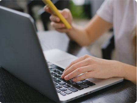 Hands typing on laptop