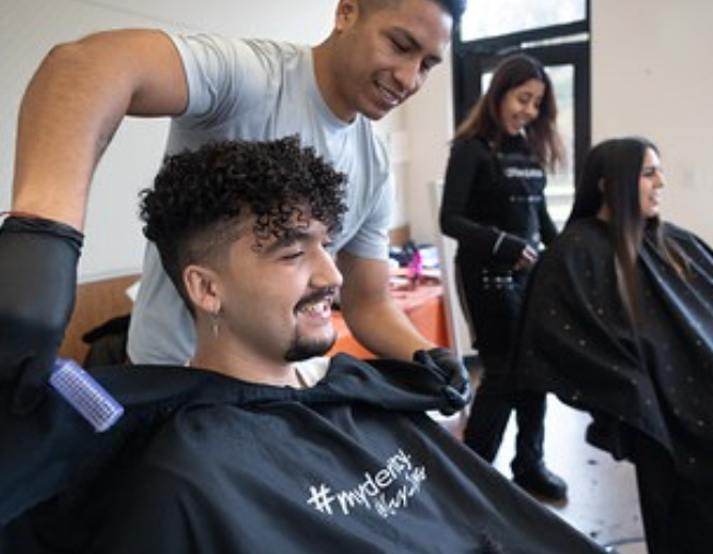 student receiving a free haircut