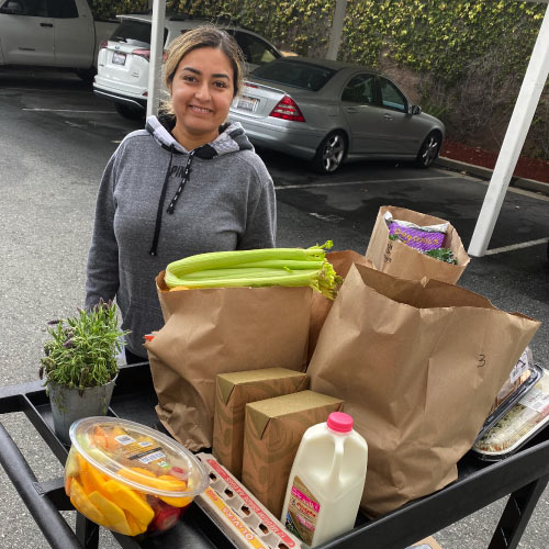 Student with cart of groceries