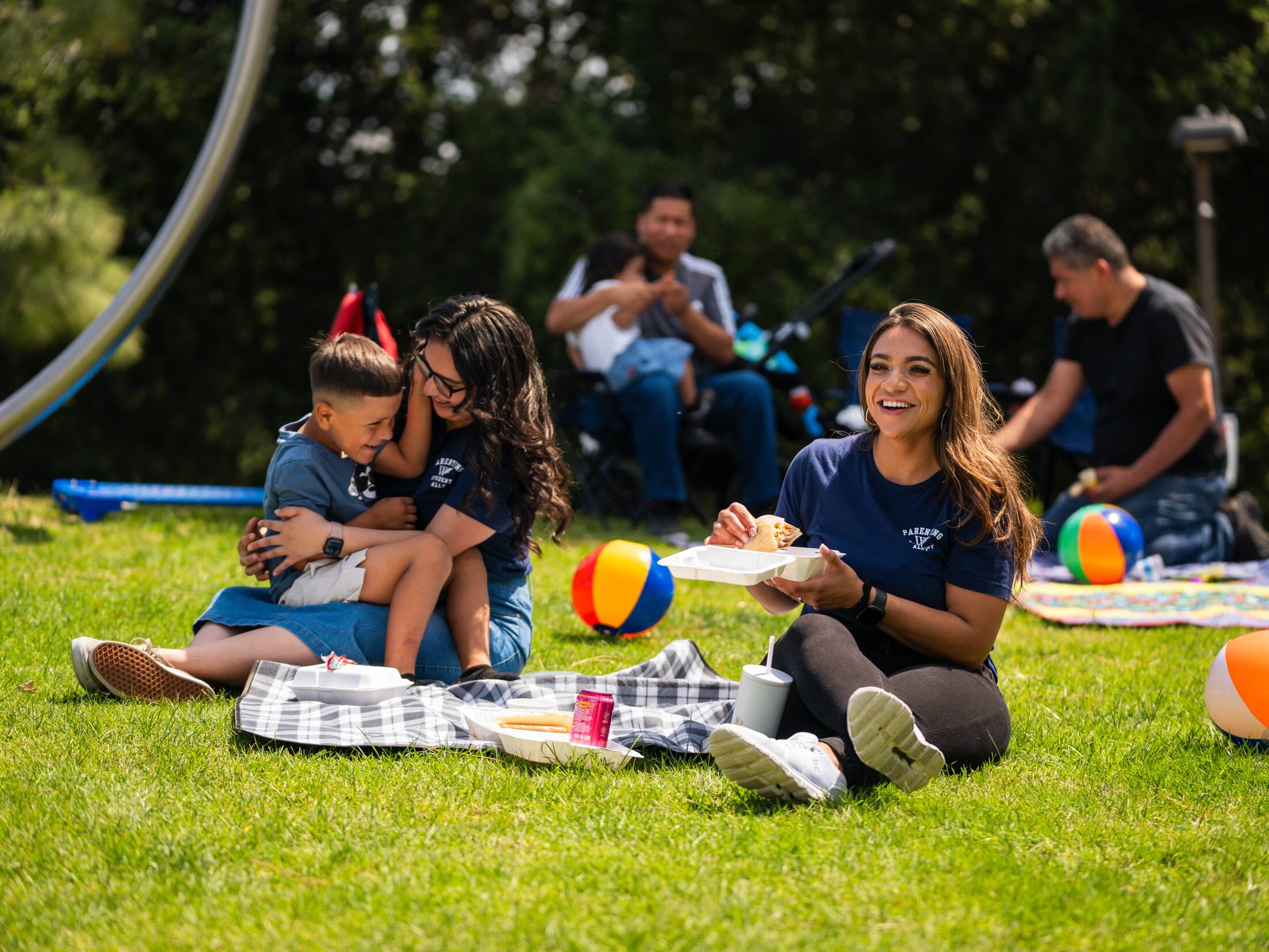 student needs staff on grass area of student-parent event