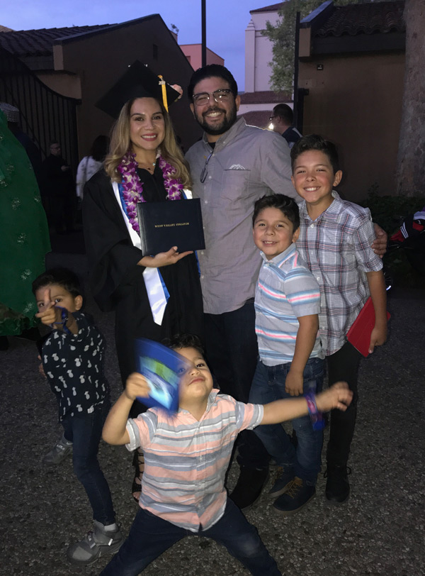 Tania with family during graduation