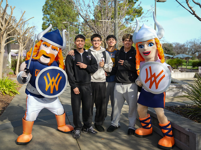 four male students posing with vik and viktoria mascots four male students posing with vik and viktoria mascots