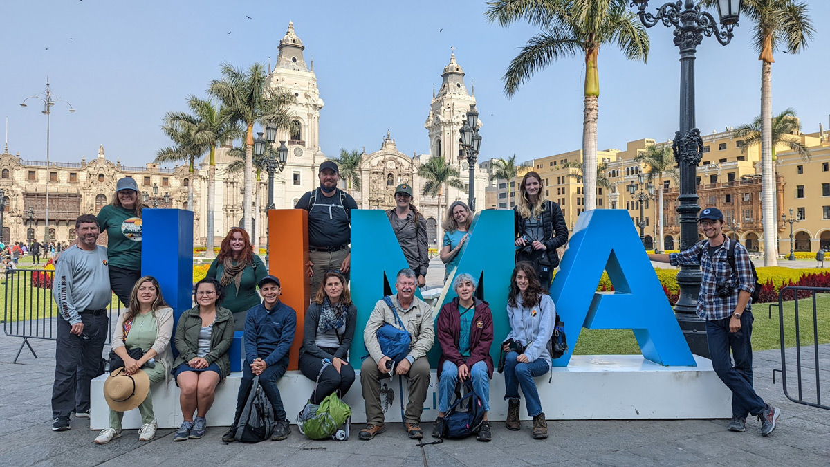 Group at Lima sign